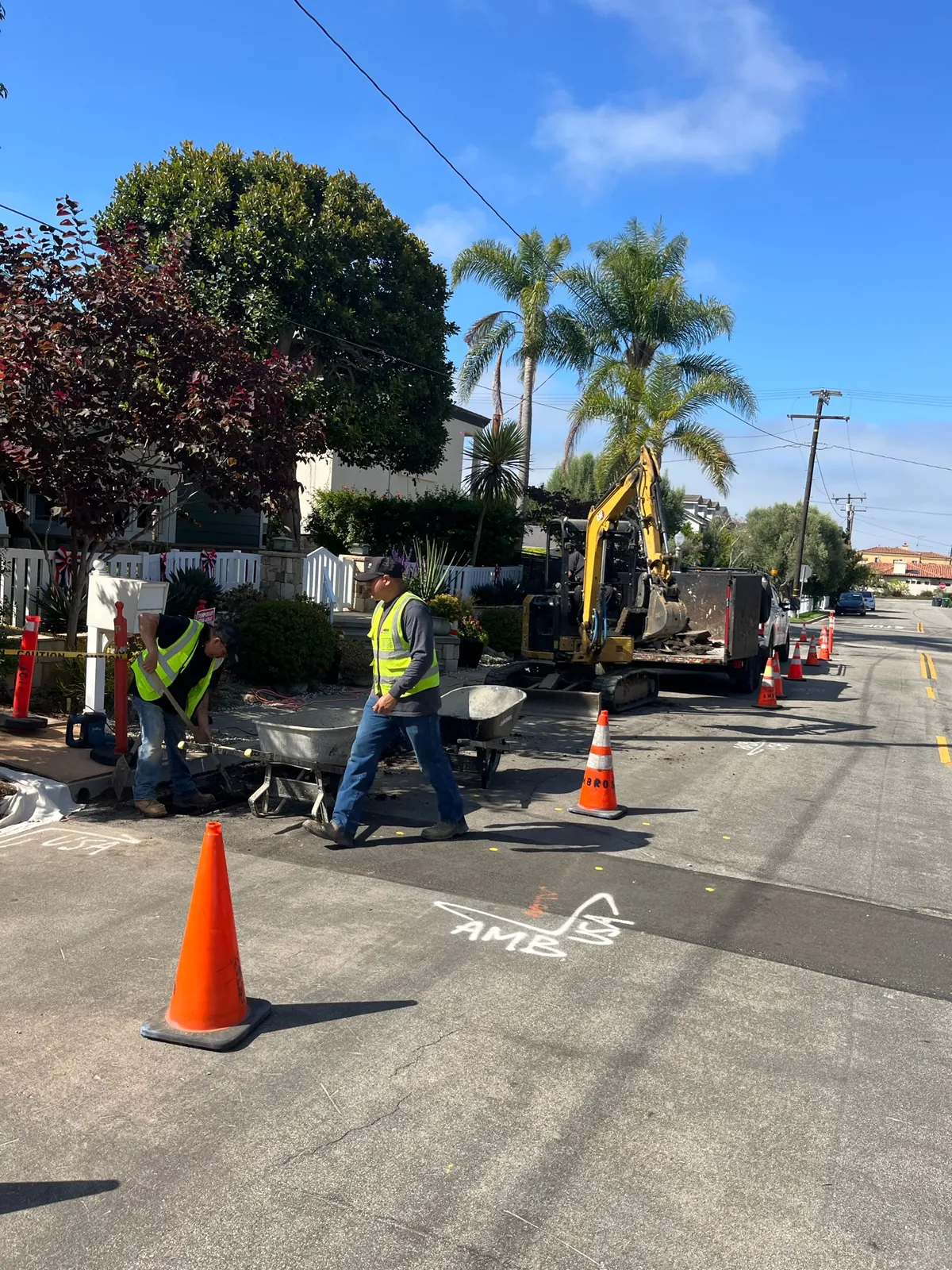 Crew and equipment during completed underground utility connection work in Newport Beach